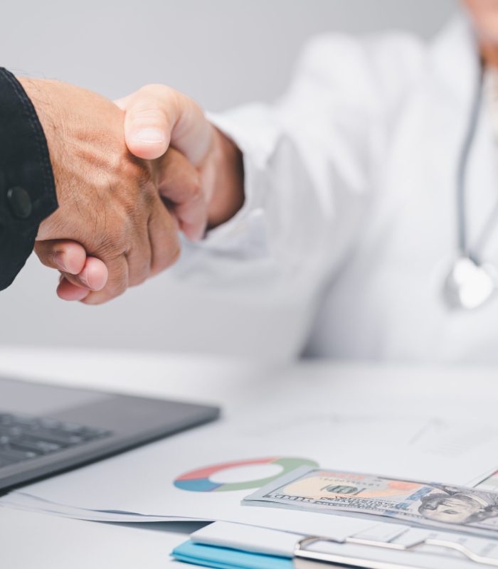 healthcare business finance concept. doctors people medical, or businessman in hospital contact accountants to check cost of equipment medical. stethoscope, chart, paperwork, laptop, and graph on deck